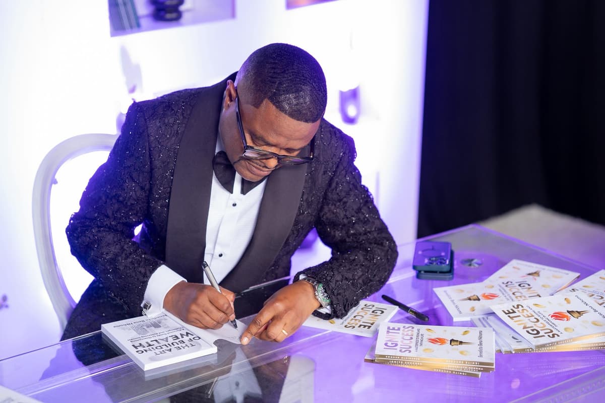 Bena Nkhoma signing his book